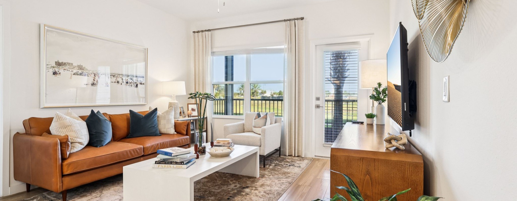 living room with seating tables and tv 1 bedroom apartments in Kissimmee FL