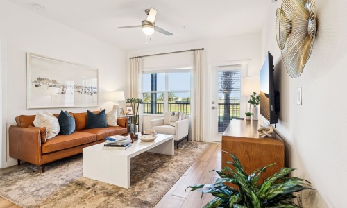 living room with seating tables and tv 1 bedroom apartments in Kissimmee FL